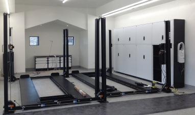 Rousseau Spider Storage with Stacked Doors and (2) ProPark 8PL 4-post lifts.